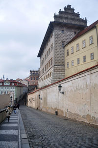 Street amidst buildings in town against sky