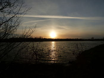 Scenic view of lake against sky during sunset