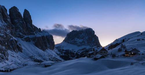 Scenic view of snow covered mountains against sky during sunset