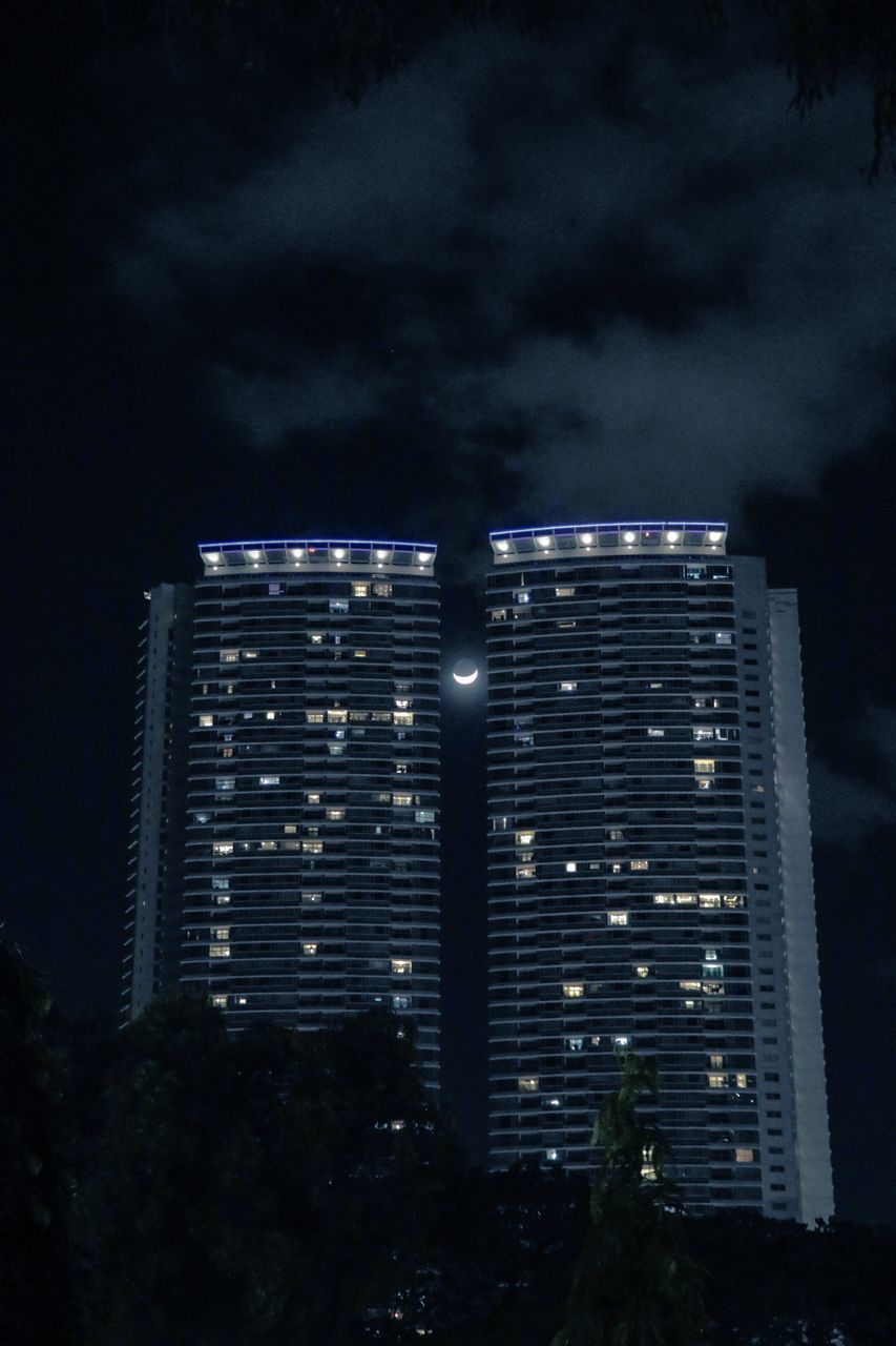 LOW ANGLE VIEW OF ILLUMINATED BUILDING AGAINST SKY