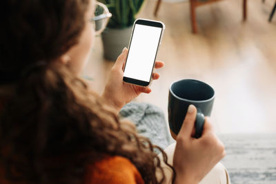 Midsection of woman using mobile phone