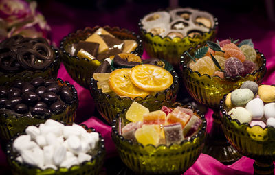 High angle view of various sweet food in bowls on table