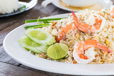 Fried rice with shrimp on the old wooden table