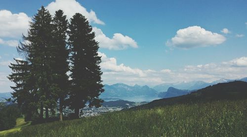 Scenic view of mountains against cloudy sky