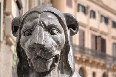 Close-up of statue against building