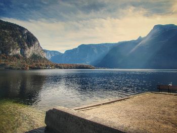 Scenic view of lake by mountains against sky