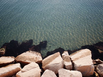 High angle view of rocks by sea