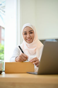 Portrait of smiling businesswoman in hijab