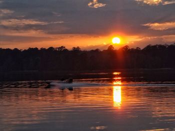 Scenic view of lake against sky during sunset