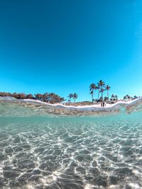 Scenic view of sea against clear blue sky