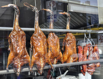 Close-up of roasted duck hanging in restaurant