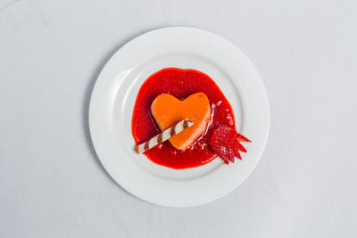 High angle view of red fruits in plate