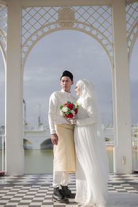 Portrait of bride standing in city