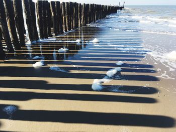 Shadow of snow on sand at beach during winter