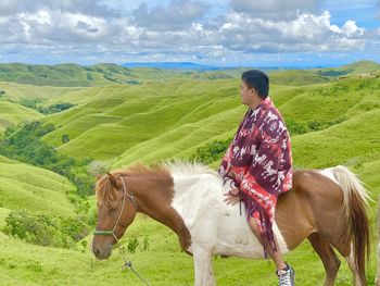 Man riding horse in a field