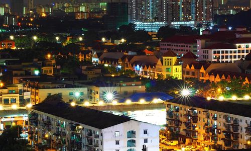 High angle view of illuminated town against sky at night