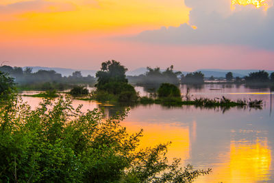 Scenic view of lake against orange sky