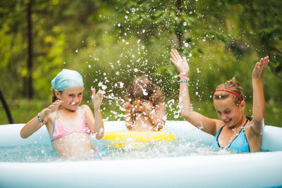 Happy girl enjoying in swimming pool