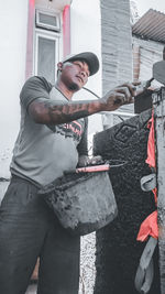 Man standing against wall