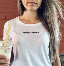 Midsection of woman holding drink standing against wall