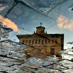 Low angle view of old building against sky during winter