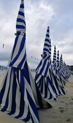 Flag on beach against sky