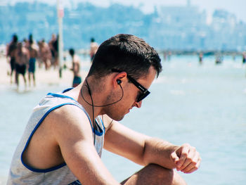 Young man looking at sea shore