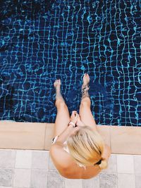 High angle view of woman relaxing in swimming pool