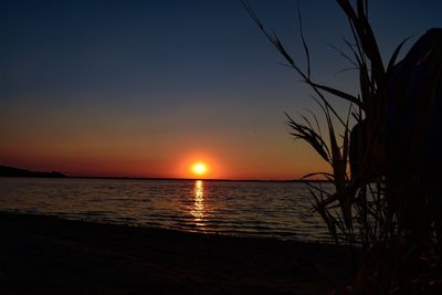 Scenic view of sea against romantic sky at sunset