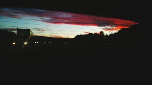 Silhouette of car against sky at night