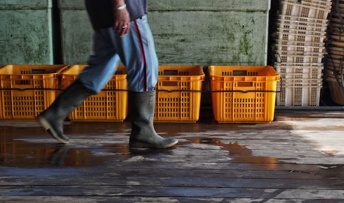 Low section of man standing in puddle