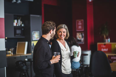 Man and woman standing at restaurant