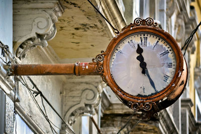 Close-up of old clock on wall