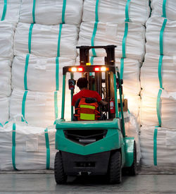 Forklift lift jumbo bag of sugar bag put up into stack