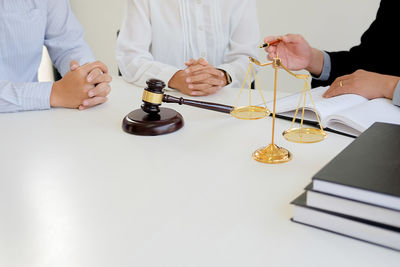 Close-up of people working on table