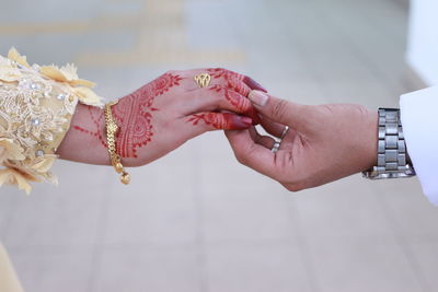 Close-up of couple with holding hands outdoors