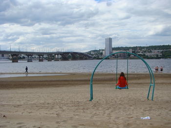 People on beach against sky