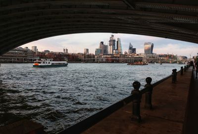 Bridge over river with city in background