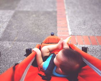 High angle view of toddler in baby carriage on footpath