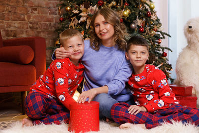 Merry christmas and happy holidays cheerful mom and her cute boys sons