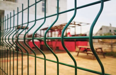 Close-up of metal fence against clear sky