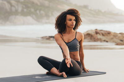 Young woman sitting on beach