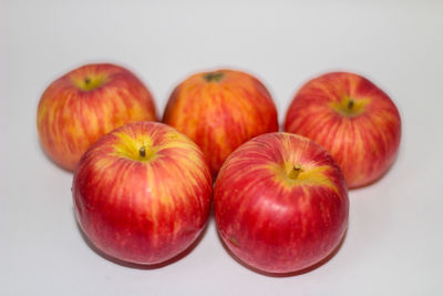 High angle view of apples on table against white background