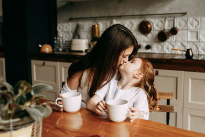 Close-up of girl at table at home