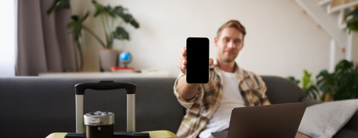 Midsection of woman using mobile phone