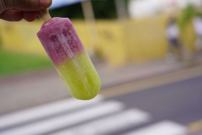 Close-up of hand holding ice cream