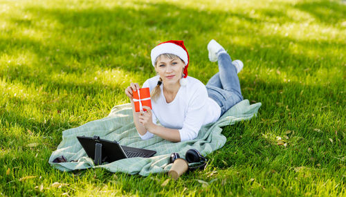 Young pensive woman using laptop in park. young girl chatting