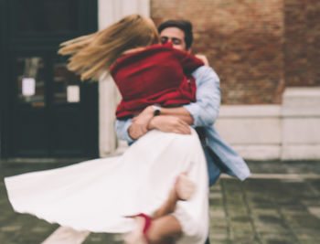 Rear view of couple holding hands