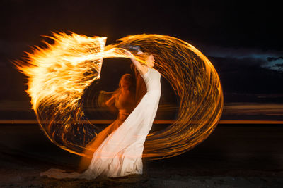 Woman with fire at beach