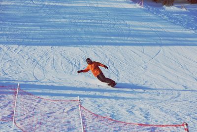 Man skiing on snow covered landscape during winter